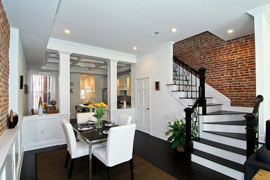 This is an example of a mid-sized transitional open plan dining in DC Metro with white walls and dark hardwood floors.