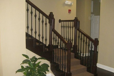Small medium tone wood floor and brown floor entryway photo in Other with beige walls and a brown front door