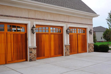 This is an example of a mid-sized transitional attached three-car garage in Dallas.
