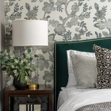 Moody Primary Bedroom with Floral Grasscloth Wallpaper Green Velvet Bed Deep War