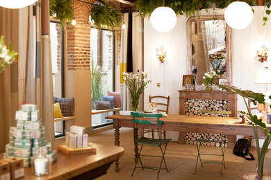 Example of a mid-sized cottage chic carpeted enclosed dining room design in Madrid with white walls and a standard fireplace