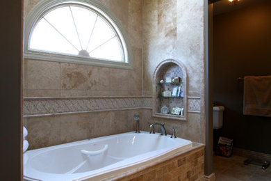 Inspiration for a mid-sized mediterranean master beige tile and stone tile travertine floor bathroom remodel in Richmond with an undermount sink, raised-panel cabinets, granite countertops, a two-piece toilet and gray walls