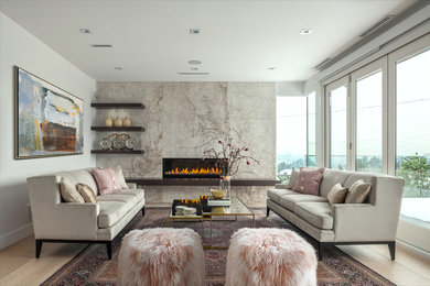 Photo of a transitional living room in Vancouver with white walls, light hardwood floors, a ribbon fireplace, a stone fireplace surround, no tv and beige floor.