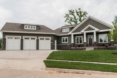 Mid-sized traditional gray one-story mixed siding house exterior idea in Cedar Rapids with a hip roof and a shingle roof