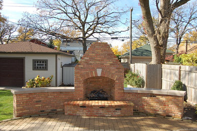 Large elegant backyard brick patio photo in Chicago with a fire pit and no cover