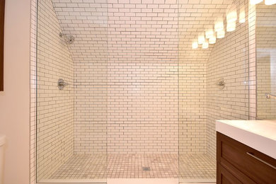 Example of a white tile and subway tile bathroom design in Chicago with a wall-mount sink