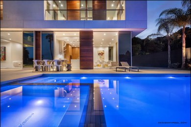 Inspiration for a mid-sized modern backyard concrete paver and rectangular lap pool landscaping remodel in Los Angeles