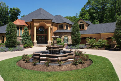 Inspiration for a huge yellow two-story stucco exterior home remodel in Cleveland