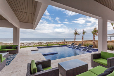 Inspiration for a large contemporary backyard stone patio kitchen remodel in Jacksonville with a roof extension