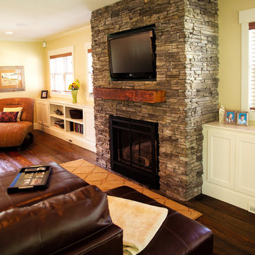 Reclaimed Wood Mantel on Floor to Ceiling Stone Fireplace in Family Room