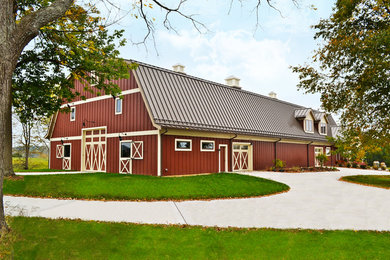 Farmhouse red two-story wood exterior home photo in Cincinnati with a gambrel roof