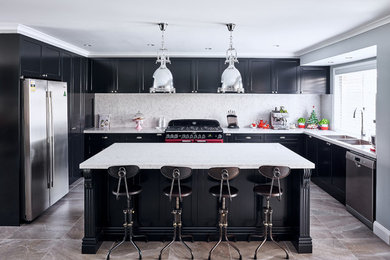 Photo of a large modern single-wall eat-in kitchen in Sydney with a double-bowl sink, beaded inset cabinets, black cabinets, marble benchtops, white splashback, stone slab splashback, black appliances, limestone floors and with island.