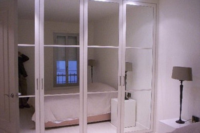 White wood modern apartment in Madrid. Bedroom with glass closet
