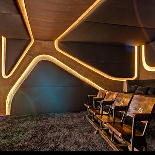 Home theater - mid-sized contemporary enclosed carpeted home theater idea in Berlin with multicolored walls and a projector screen
