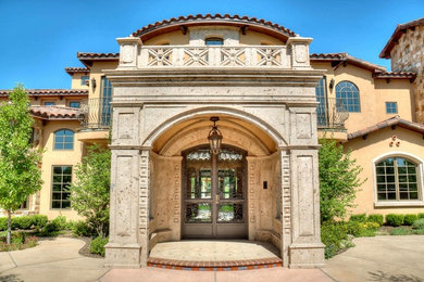 Inspiration for a mediterranean double front door remodel in Phoenix with a metal front door