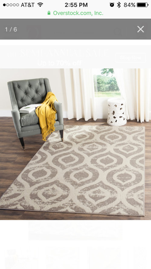 Coordinating curtains and area rug for family room