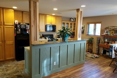 Inspiration for a kitchen remodel in Other with solid surface countertops, black appliances and gray countertops