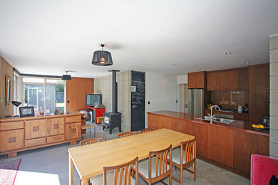 Small trendy galley eat-in kitchen photo in Christchurch with medium tone wood cabinets and an island
