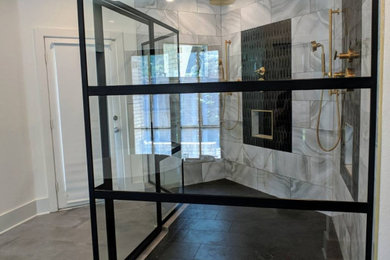Double shower - contemporary master gray tile double shower idea in Dallas with a hinged shower door and a niche