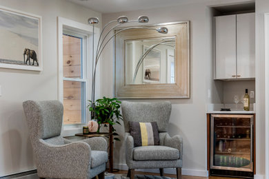 Living room - large transitional open concept medium tone wood floor living room idea in Boston with a bar and gray walls