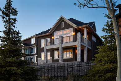 Mid-sized transitional brown one-story stucco exterior home photo in Calgary