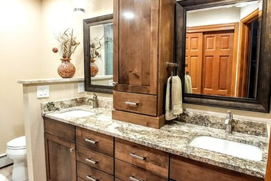 Design ideas for a mid-sized country master bathroom in Denver with shaker cabinets, dark wood cabinets, beige walls, porcelain floors, granite benchtops and grey floor.