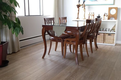 Example of a large classic light wood floor kitchen/dining room combo design in Vancouver with beige walls and no fireplace
