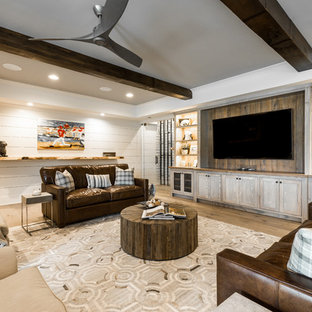 Country basement in Atlanta with white walls, light hardwood flooring and brown floors.