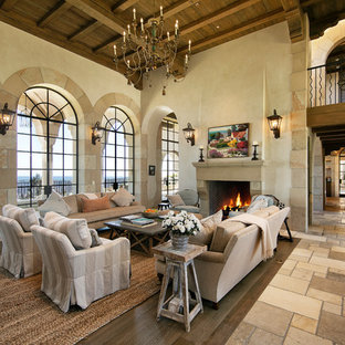 Living room - mediterranean beige floor living room idea in Santa Barbara with white walls and a standard fireplace