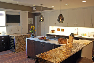 Inspiration for a large timeless l-shaped medium tone wood floor eat-in kitchen remodel in Baltimore with an undermount sink, flat-panel cabinets, dark wood cabinets, solid surface countertops, white backsplash, stainless steel appliances and two islands
