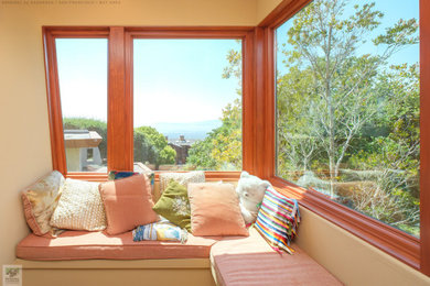 Example of a large medium tone wood floor, multicolored floor and vaulted ceiling bedroom design in San Francisco with beige walls and no fireplace