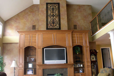Example of a large open concept family room design in Cleveland with a media wall