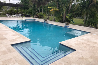 Large contemporary backyard rectangular pool in Miami with a hot tub and tile.
