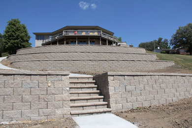 Design ideas for a large backyard retaining wall landscape in Other.