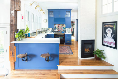 Inspiration for an eclectic kitchen in Boston with blue cabinets.
