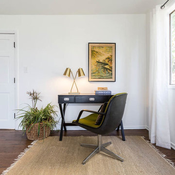 Green Knoll office chair, black campaign desk, MCM lamp