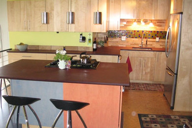 Kitchen - mid-sized contemporary brown floor kitchen idea in Other with an undermount sink, flat-panel cabinets, light wood cabinets, beige backsplash, matchstick tile backsplash, stainless steel appliances and an island