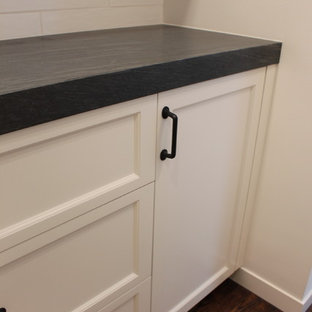 Design ideas for a country kitchen pantry in San Francisco with white cabinets, soapstone benchtops, white splashback and no island.