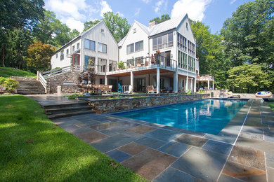 This is an example of a large traditional backyard rectangular lap pool in Baltimore with tile.