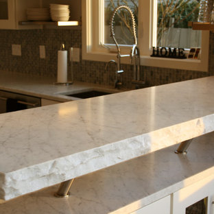 Design ideas for a large midcentury u-shaped eat-in kitchen in Portland with an undermount sink, recessed-panel cabinets, white cabinets, marble benchtops, grey splashback, mosaic tile splashback, stainless steel appliances, medium hardwood floors, with island, red floor and white benchtop.