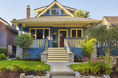 Inspiration for a mid-sized timeless blue two-story concrete fiberboard exterior home remodel in Vancouver with a clipped gable roof