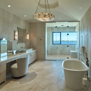 Bathroom - mediterranean master beige tile beige floor bathroom idea in Dallas with flat-panel cabinets, light wood cabinets, beige walls, a vessel sink, a hinged shower door and yellow countertops