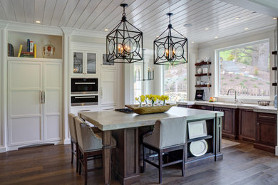 Inspiration for a transitional u-shaped medium tone wood floor, brown floor and shiplap ceiling open concept kitchen remodel in San Francisco with an undermount sink, raised-panel cabinets, white cabinets, white backsplash, paneled appliances, an island and gray countertops