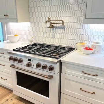 Matte white appliances with champagne bronze hardware