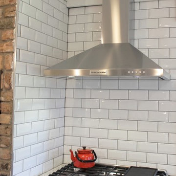 Atkinson, IL- Ranch Home Remodel With Bright White Cabinets and Brick Wall