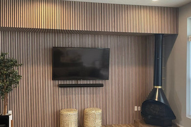 Example of a minimalist wood wall living room design in Cincinnati