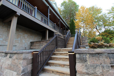 Example of a large classic beige two-story mixed siding exterior home design in New York