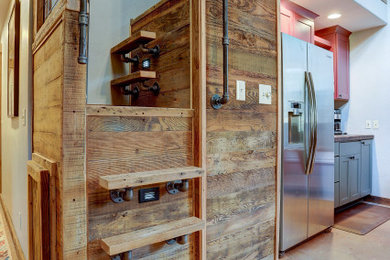 Small mountain style wooden l-shaped metal railing staircase photo in Other with metal risers
