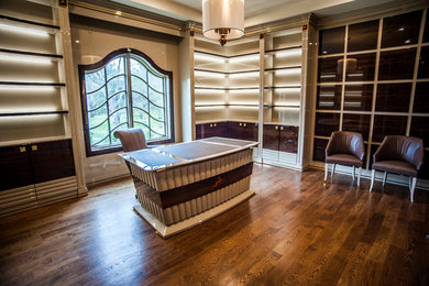 Large transitional freestanding desk medium tone wood floor study room photo in DC Metro with brown walls