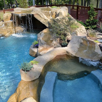 Faux rock grotto with waterfall into gunite pool. Spa with waterfall
